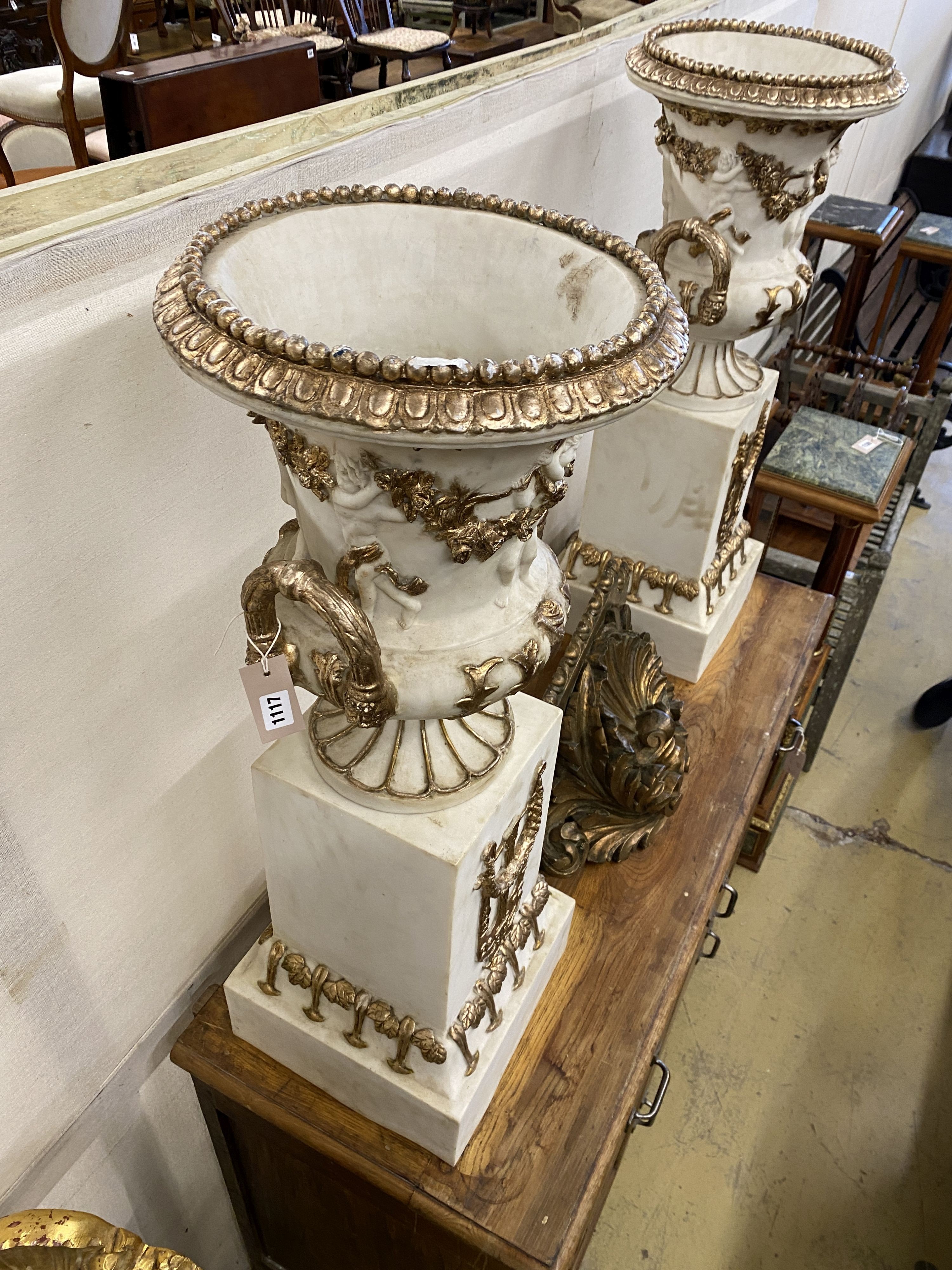 A pair of composition faux marble campana garden urns on stands, width 30cm, height 93cm